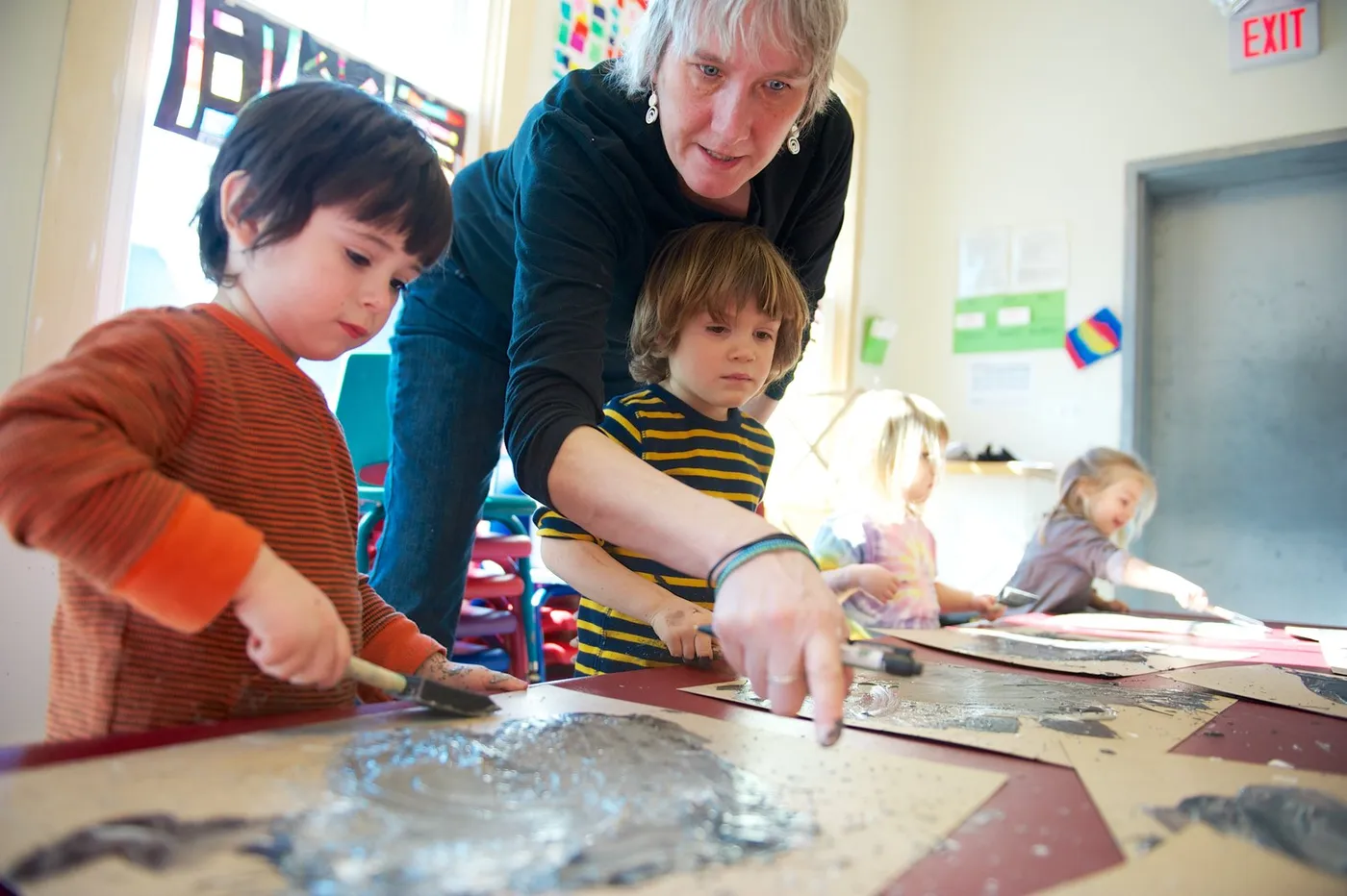 A teacher and children working on an art project at Summer Street Preschool
