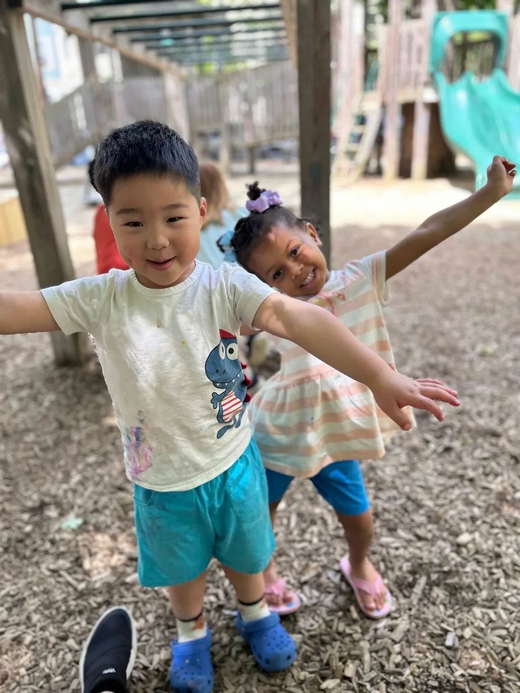 Two children playing outdoors at Cambridge-Ellis School