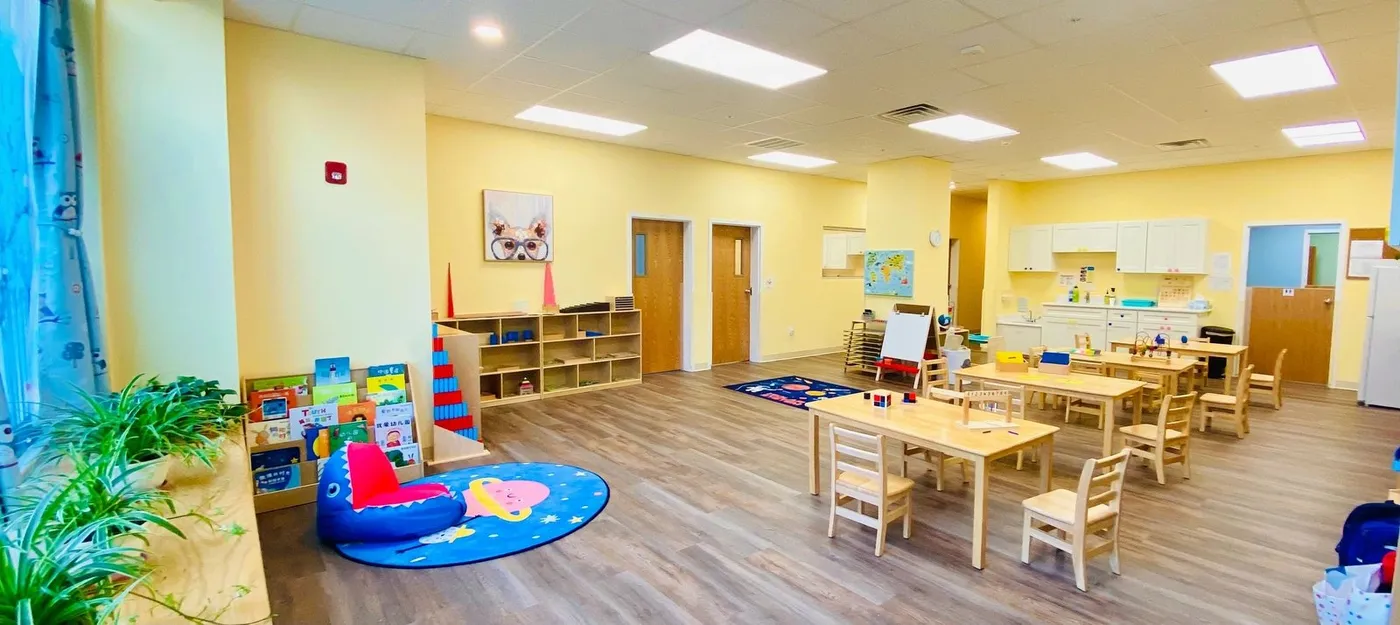 Bright classroom with low shelves and tables at Blooming Stars Education Center in Brighton