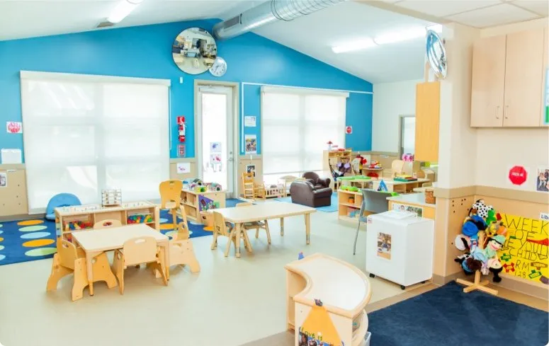 Bright classroom with small tables and play areas at Educare Chicago