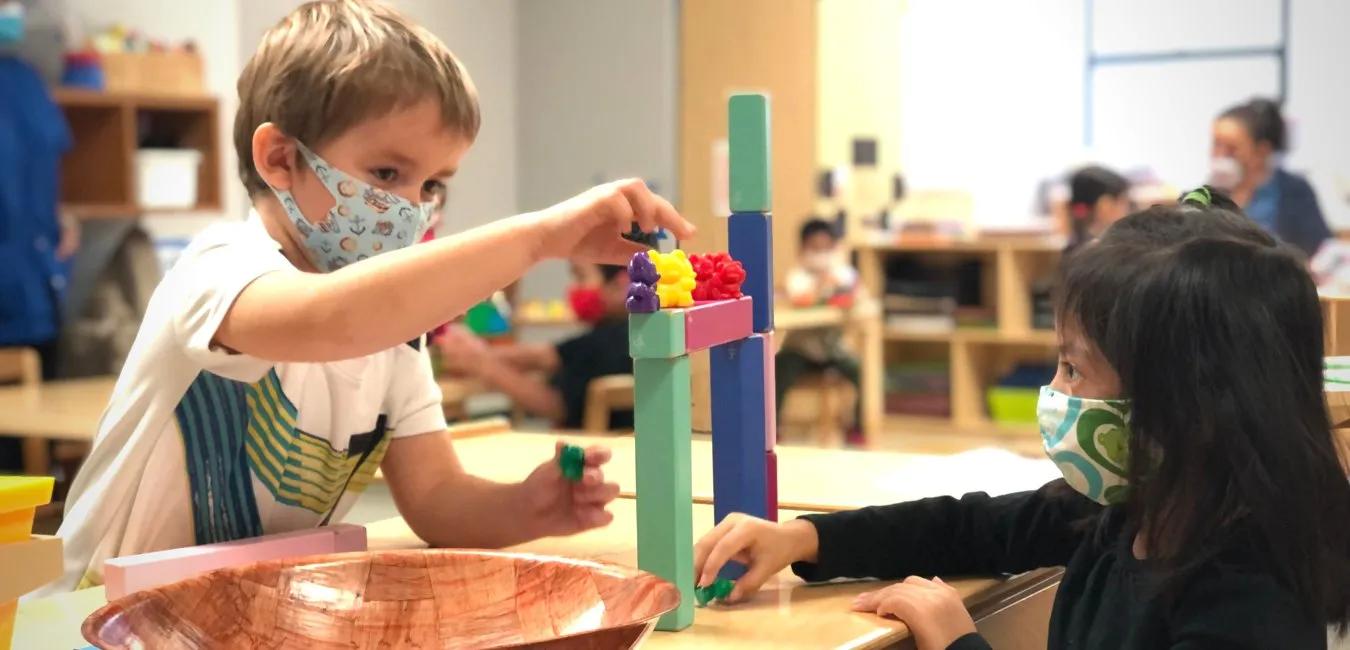 Two preschoolers building with blocks in an Erie Neighborhood House classroom