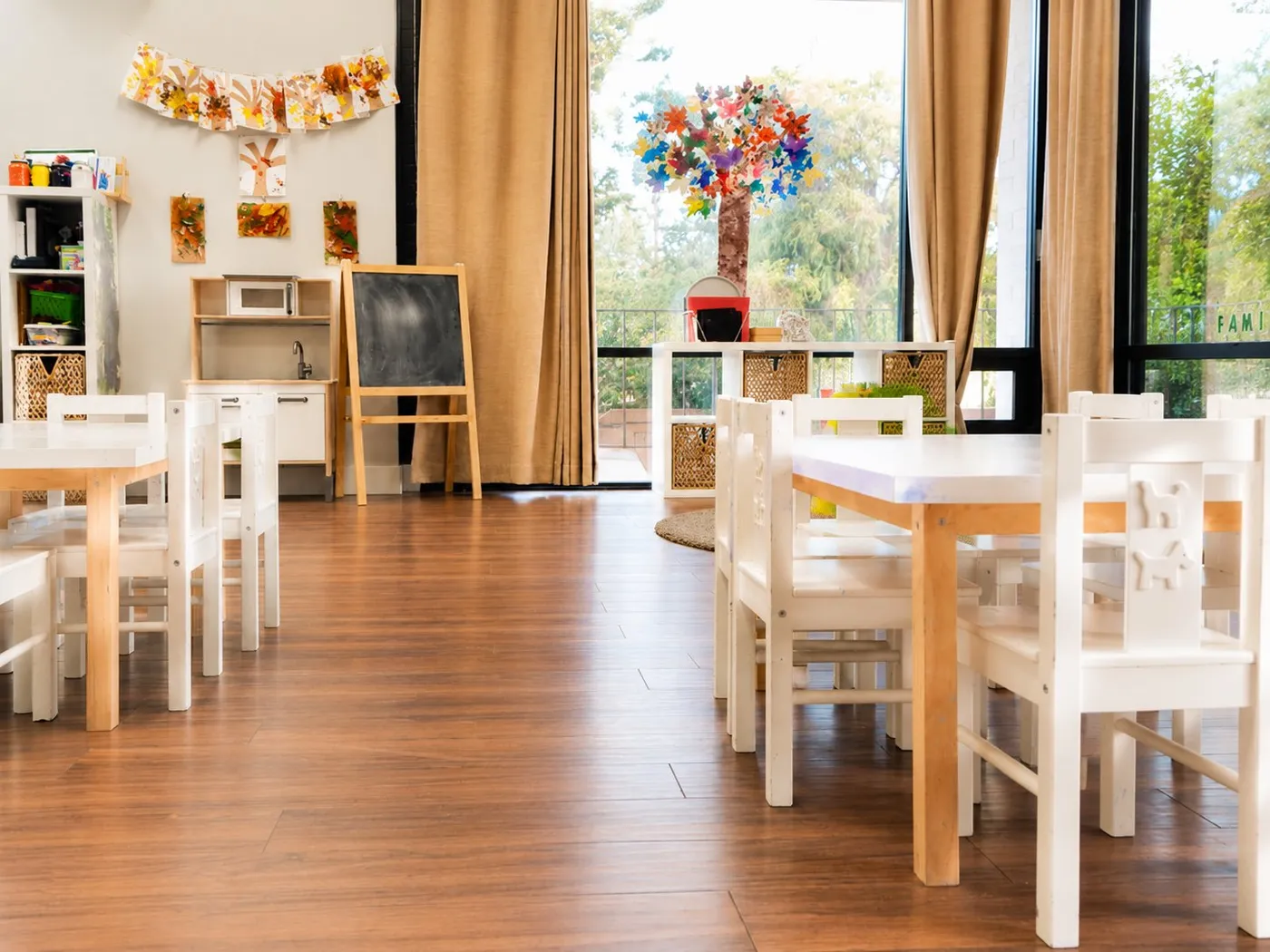 Bright classroom with child-size tables and a chalkboard at Learning Jungle Adams