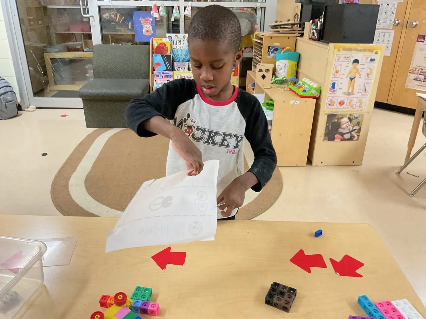 Child at an activity table at Red Apple Day Care