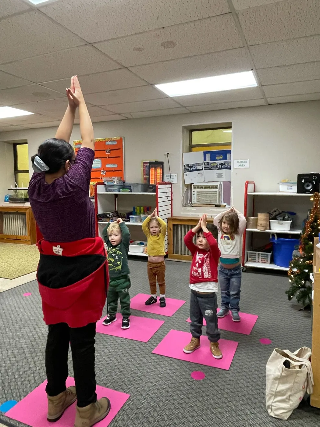Children doing yoga with a teacher at Leroux Froebel Bilingual School