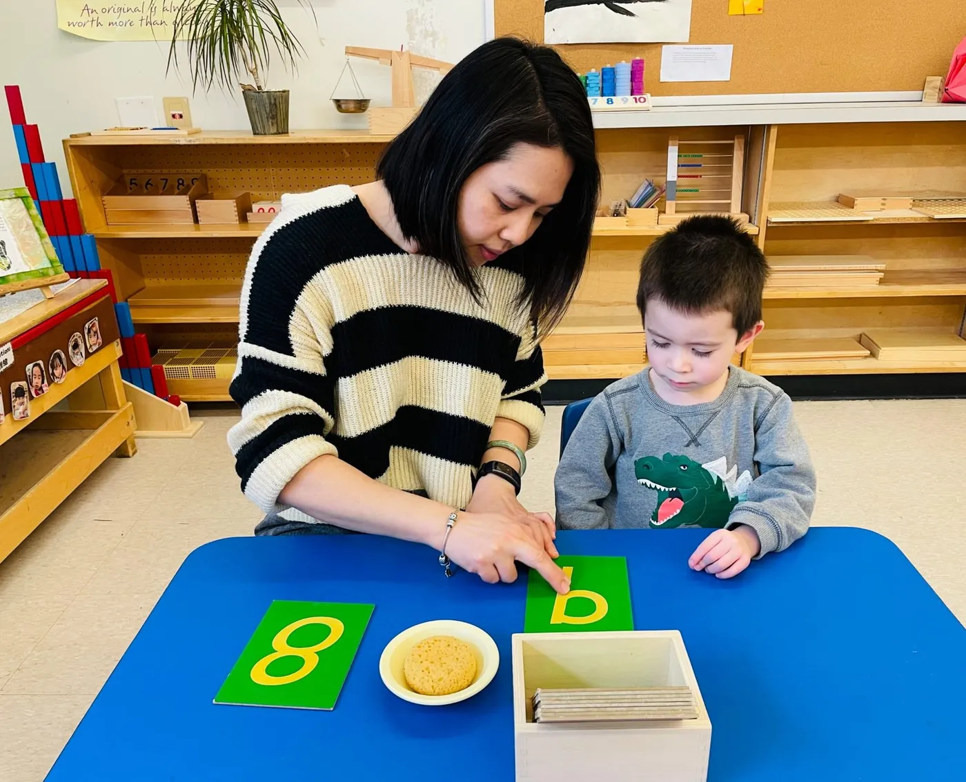 Teacher and child working with Montessori sandpaper letters at Jingbao